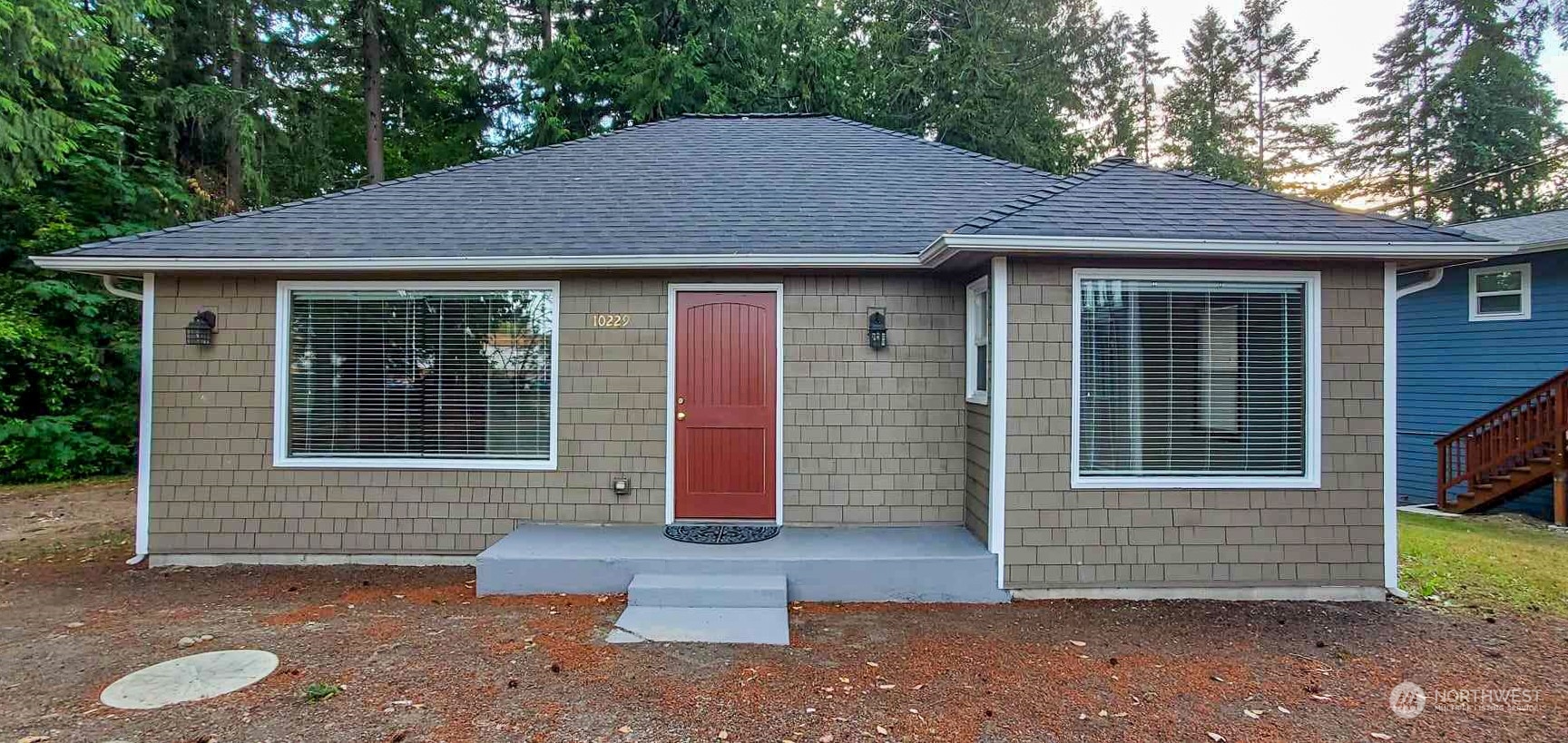 a front view of a house with a garden