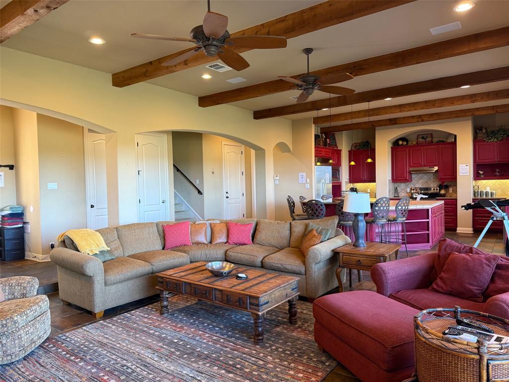 a living room with furniture a rug and a chandelier