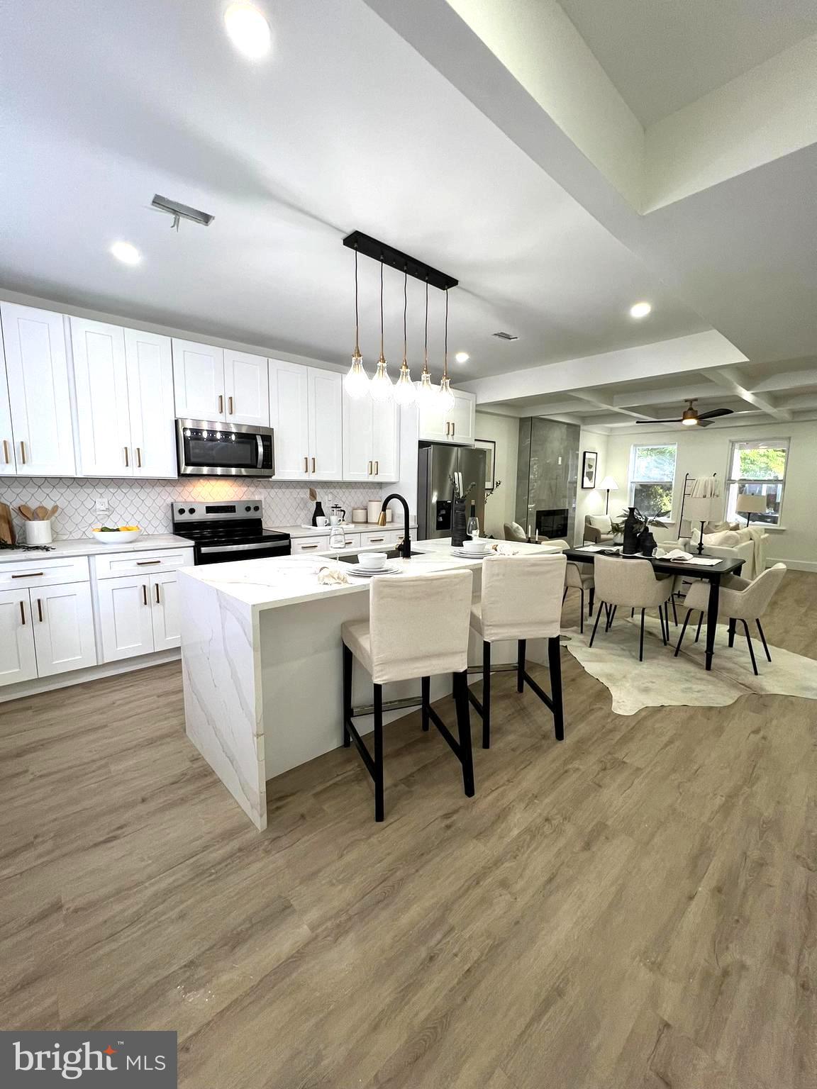 a large kitchen with a table and chairs