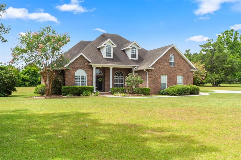 a front view of a house with a garden