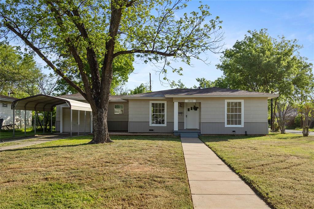 a front view of house with yard and trees