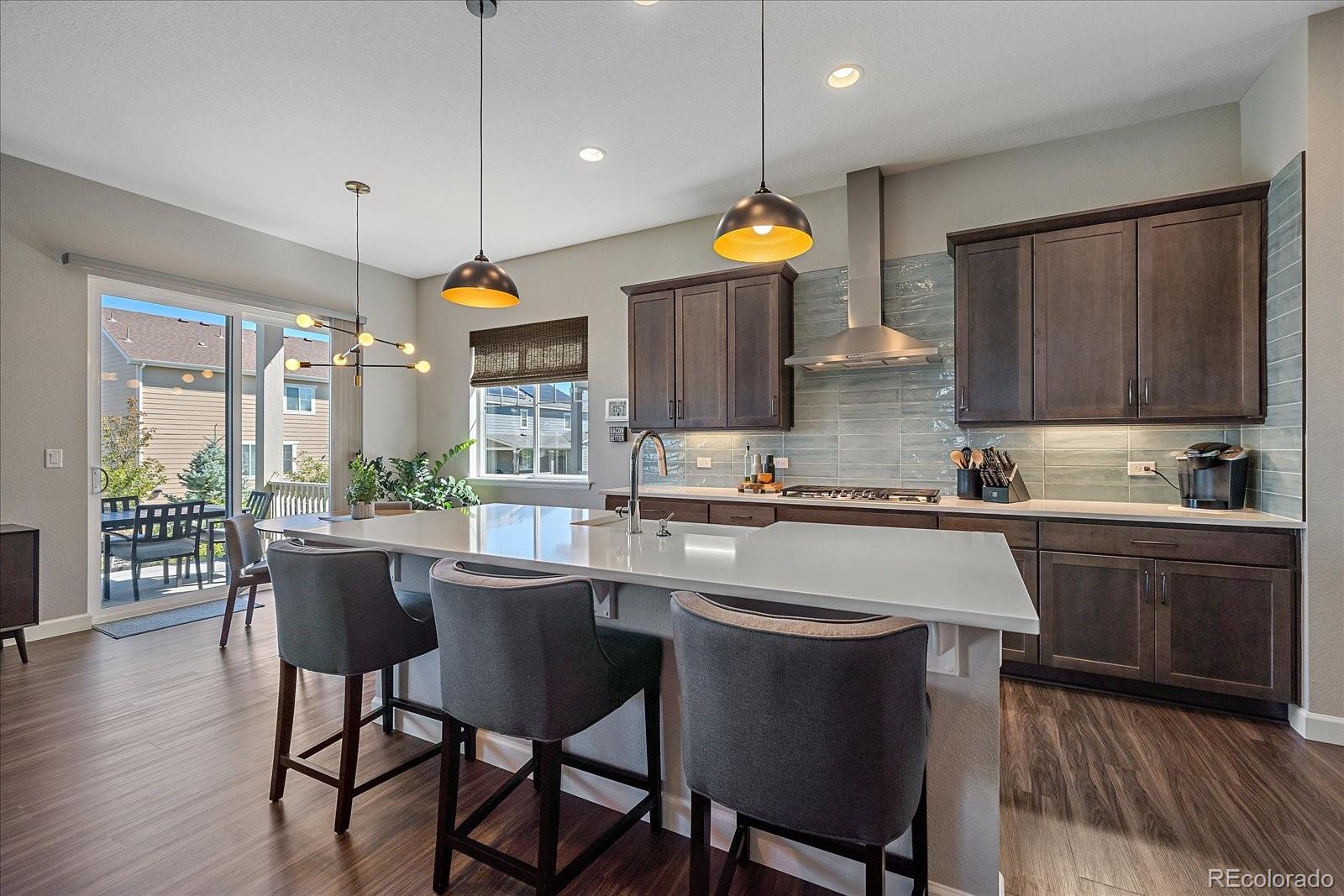 a kitchen with a table chairs sink and cabinets