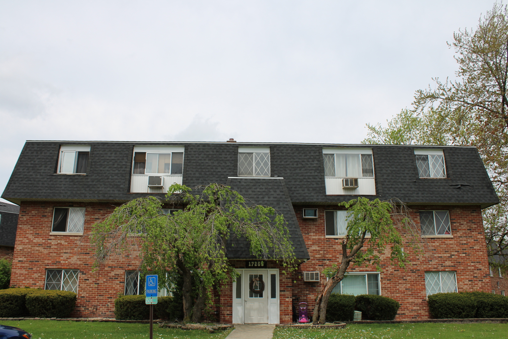 a front view of a house with plants