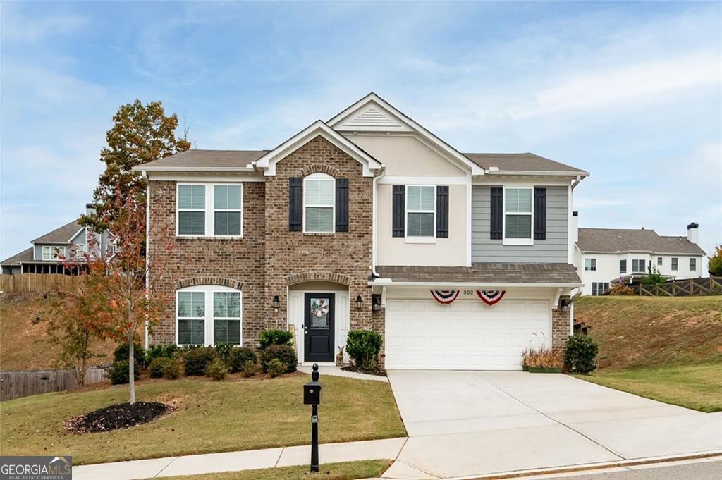 a front view of a house with garage