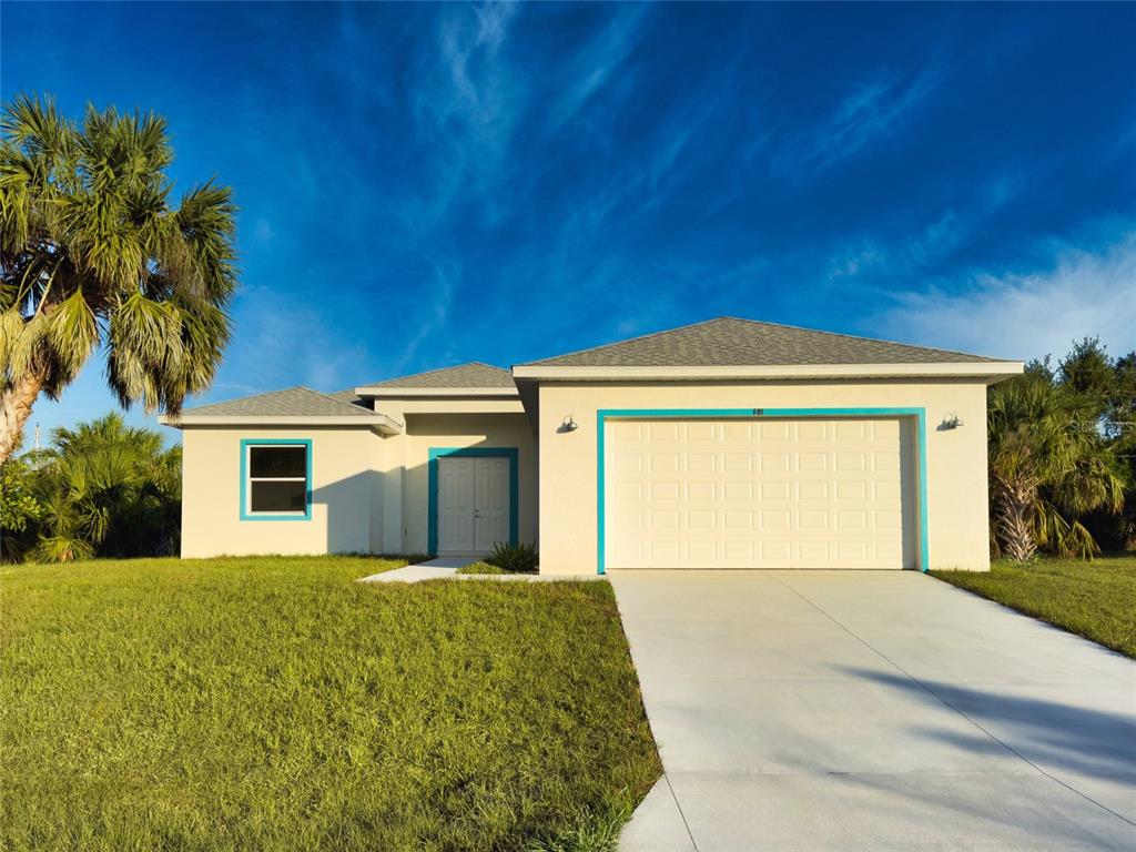 a front view of a house with a yard and garage