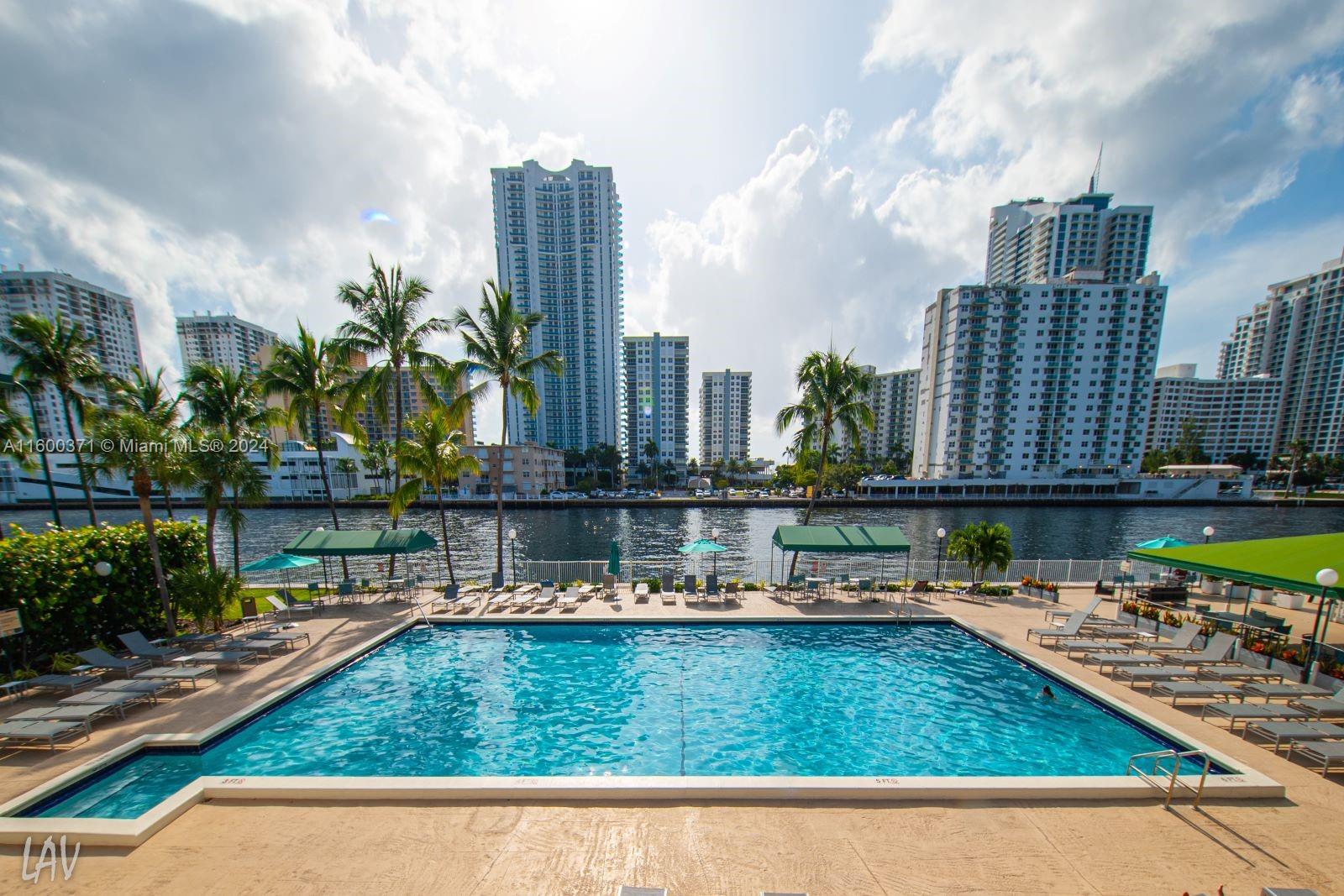 a view of swimming pool with outdoor seating and city view