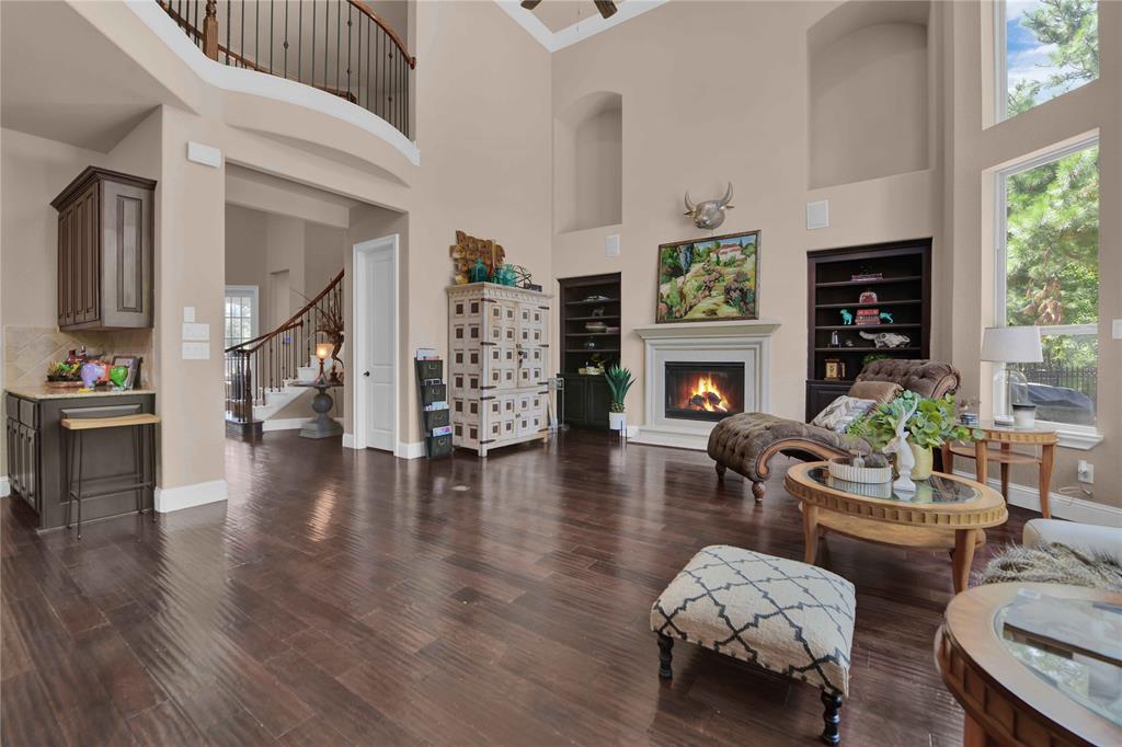 a living room with fireplace furniture and a wooden floor