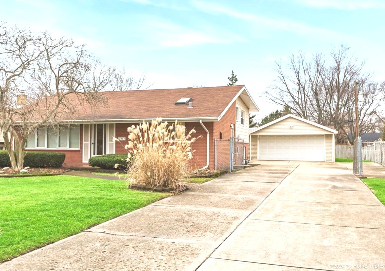 a view of a house with a yard and pathway