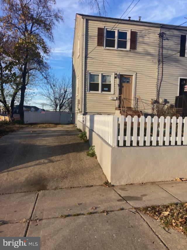 a view of a house with a wooden fence