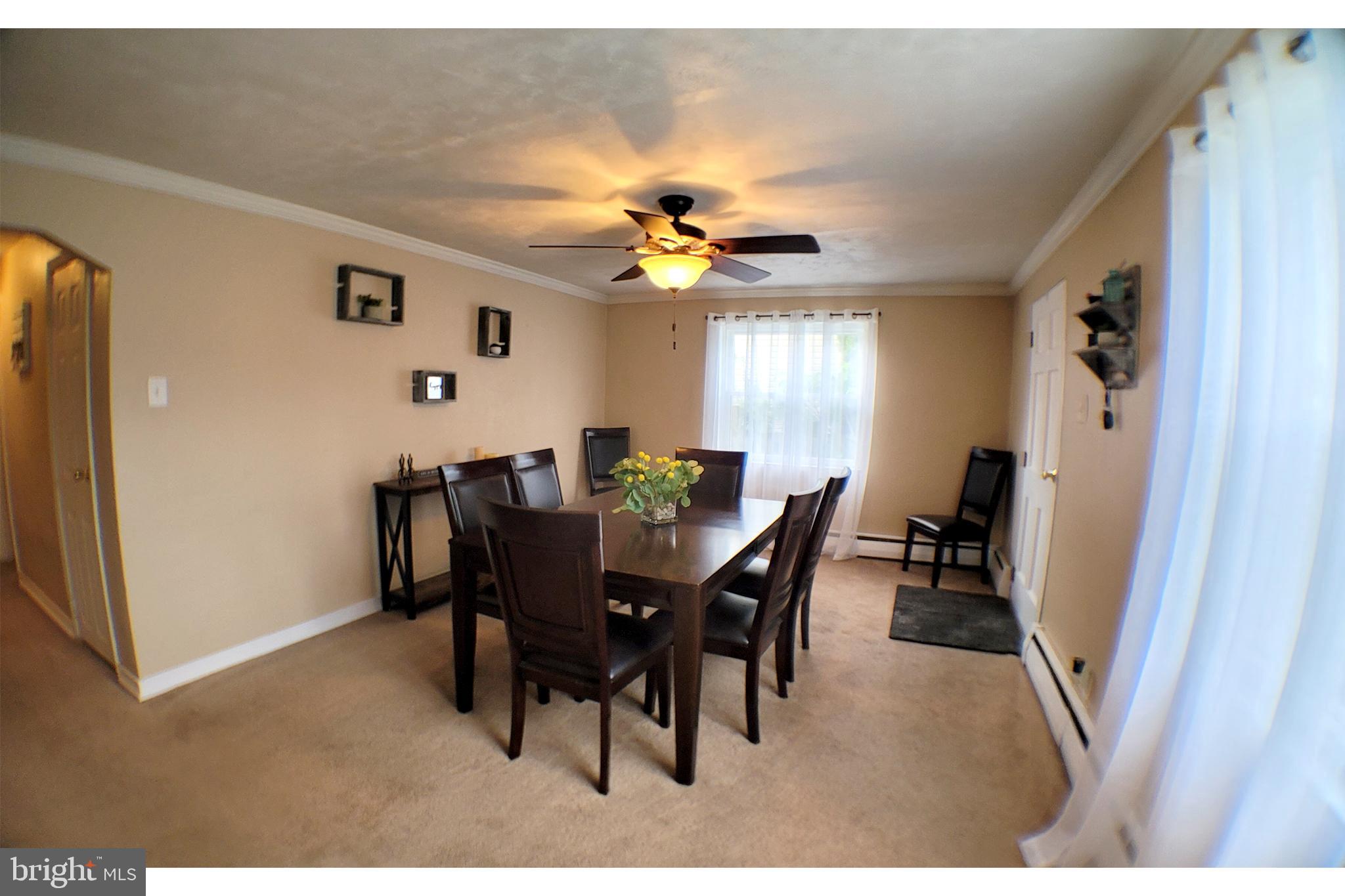 a view of a dining room with furniture and a chandelier