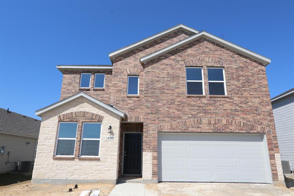 a front view of a house with garage