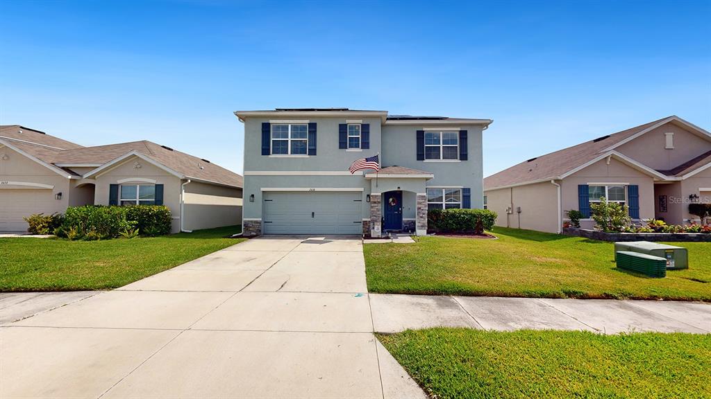 a front view of house with yard and green space