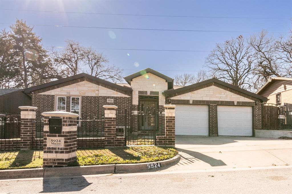 a front view of a house with a yard garage and outdoor seating