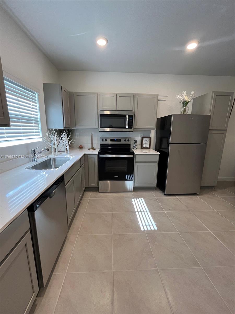 a kitchen with a stove and a refrigerator