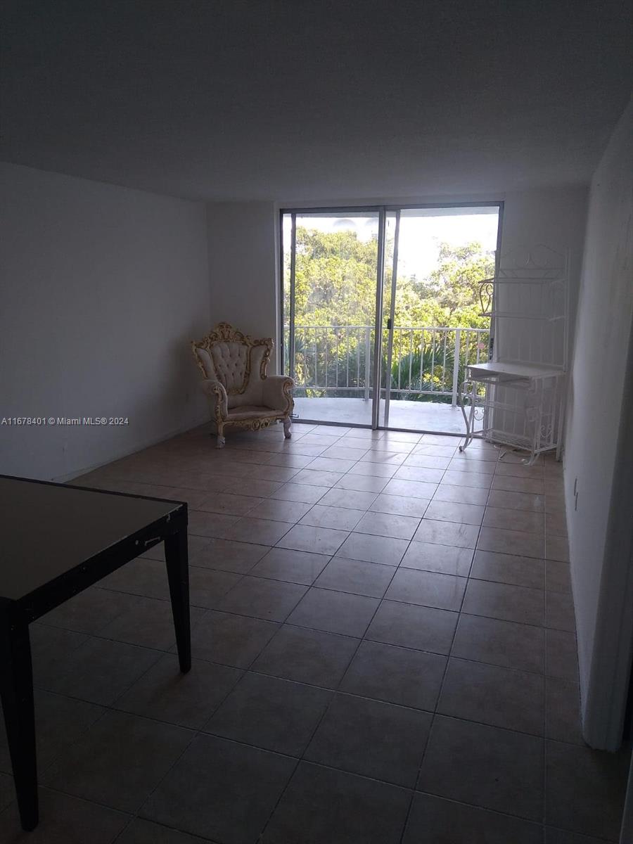 a view of empty room with lounge chair