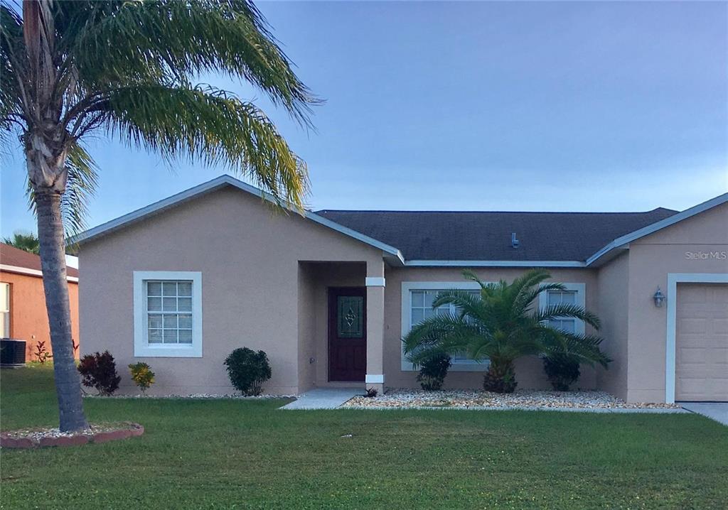 a front view of house with yard and green space