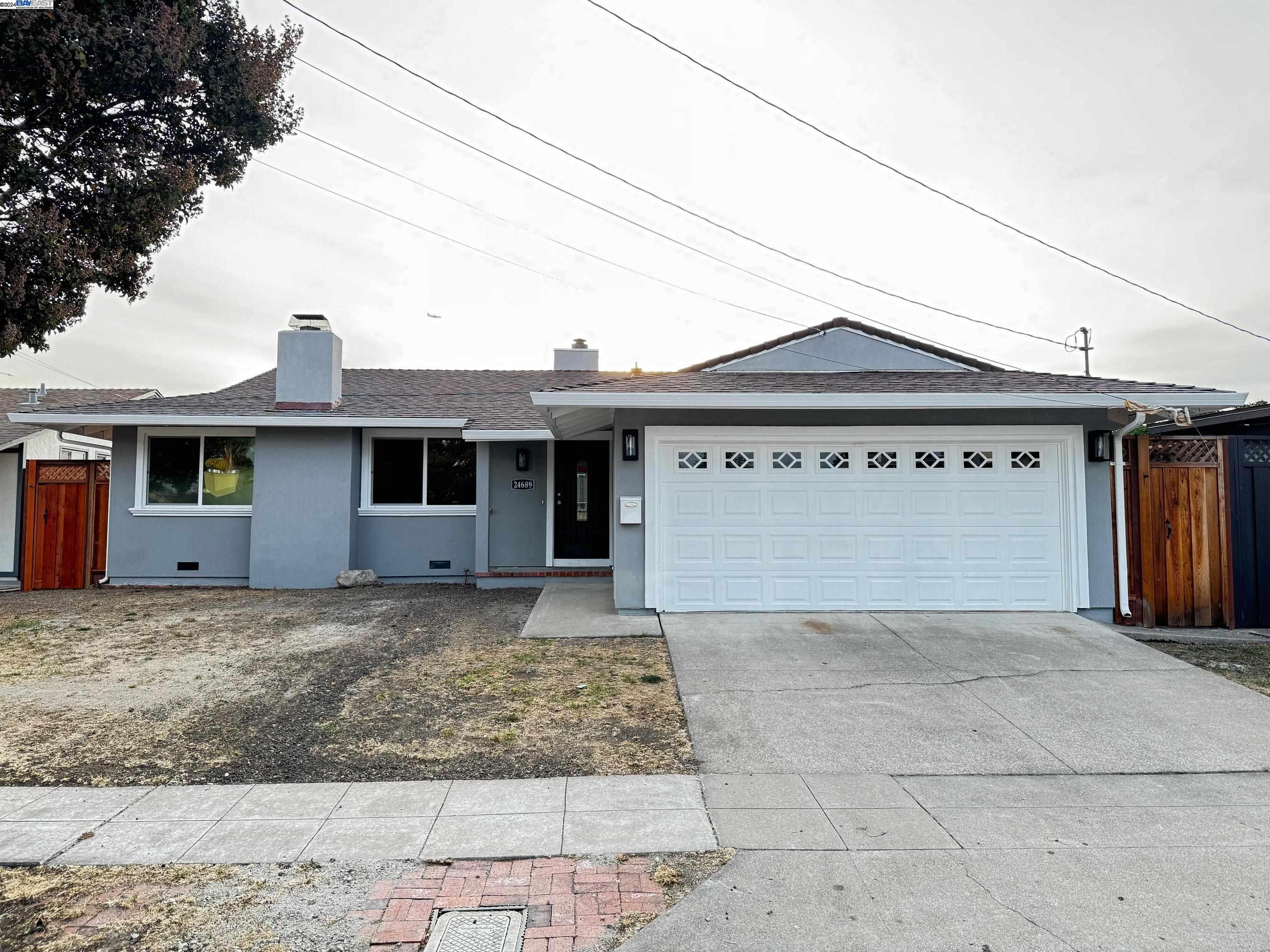 a front view of a house with a garden and garage