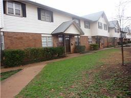 a front view of a house with a yard and porch