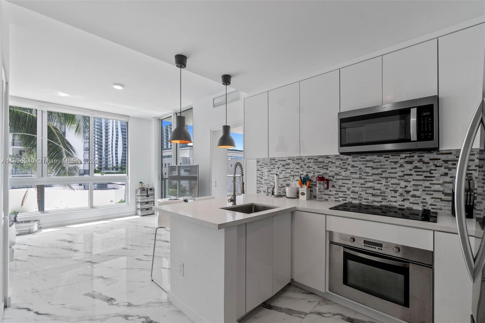 a kitchen with stainless steel appliances a stove sink microwave and cabinets