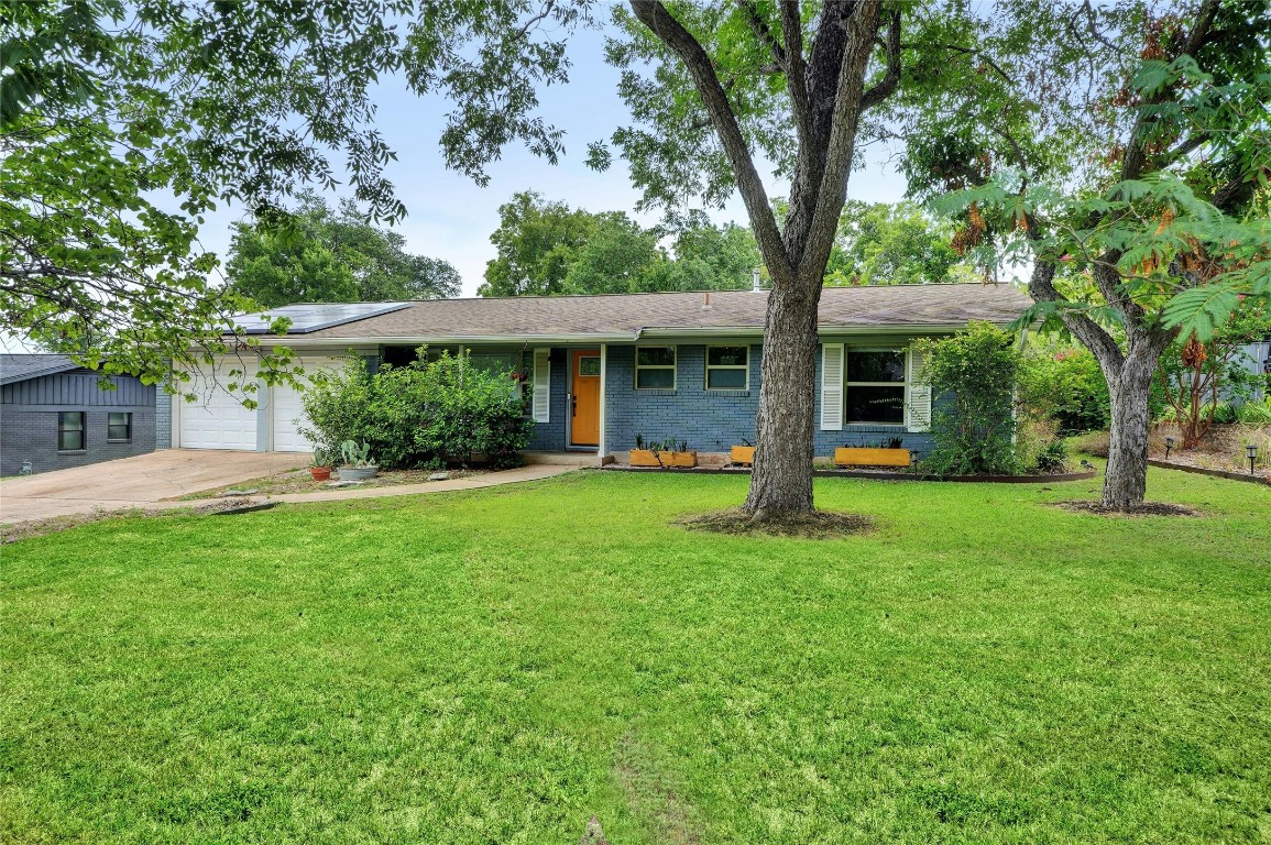 Large and welcoming front yard with beautiful mature trees.