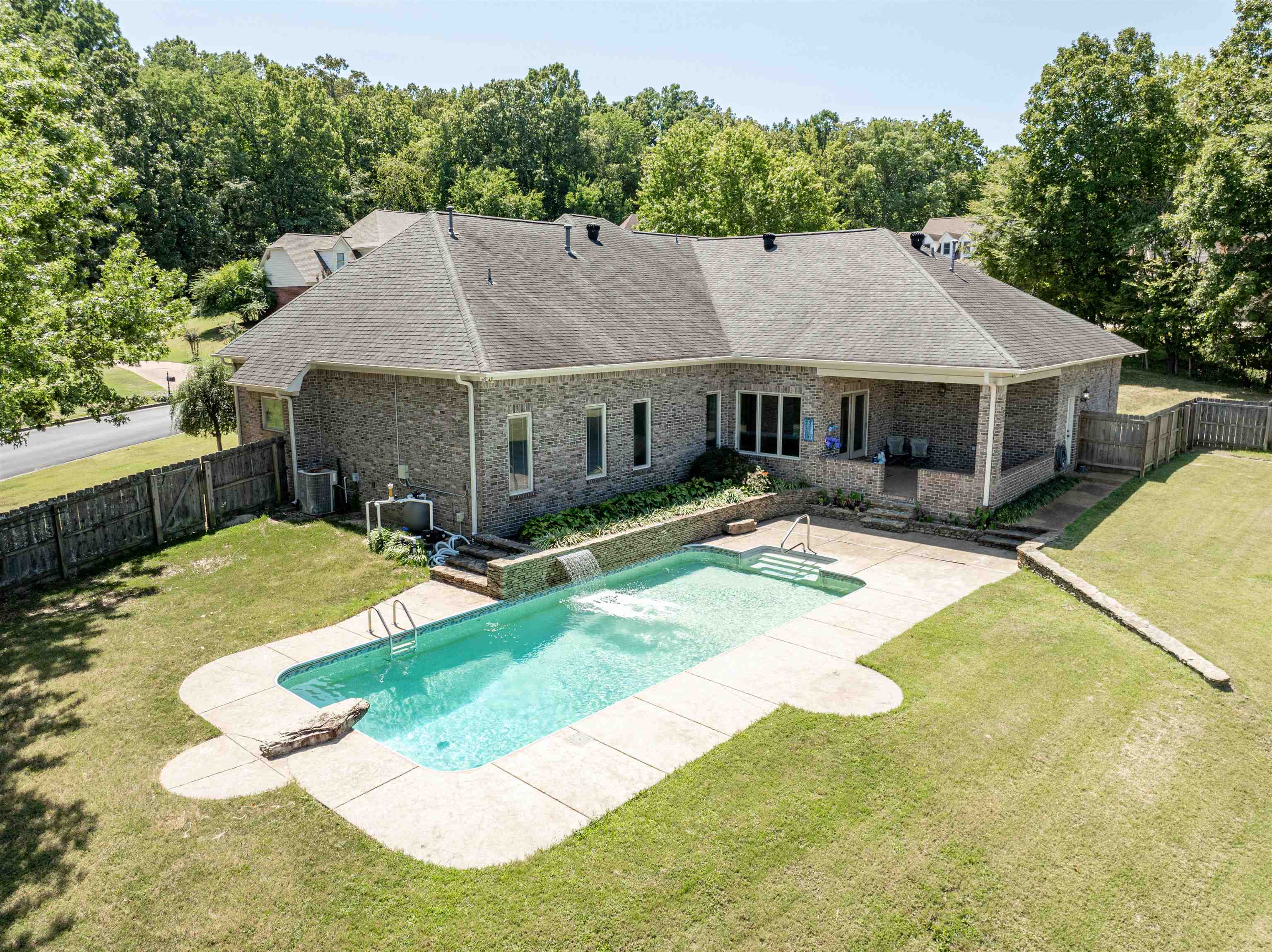 View of swimming pool with central air condition unit, a patio, and a yard