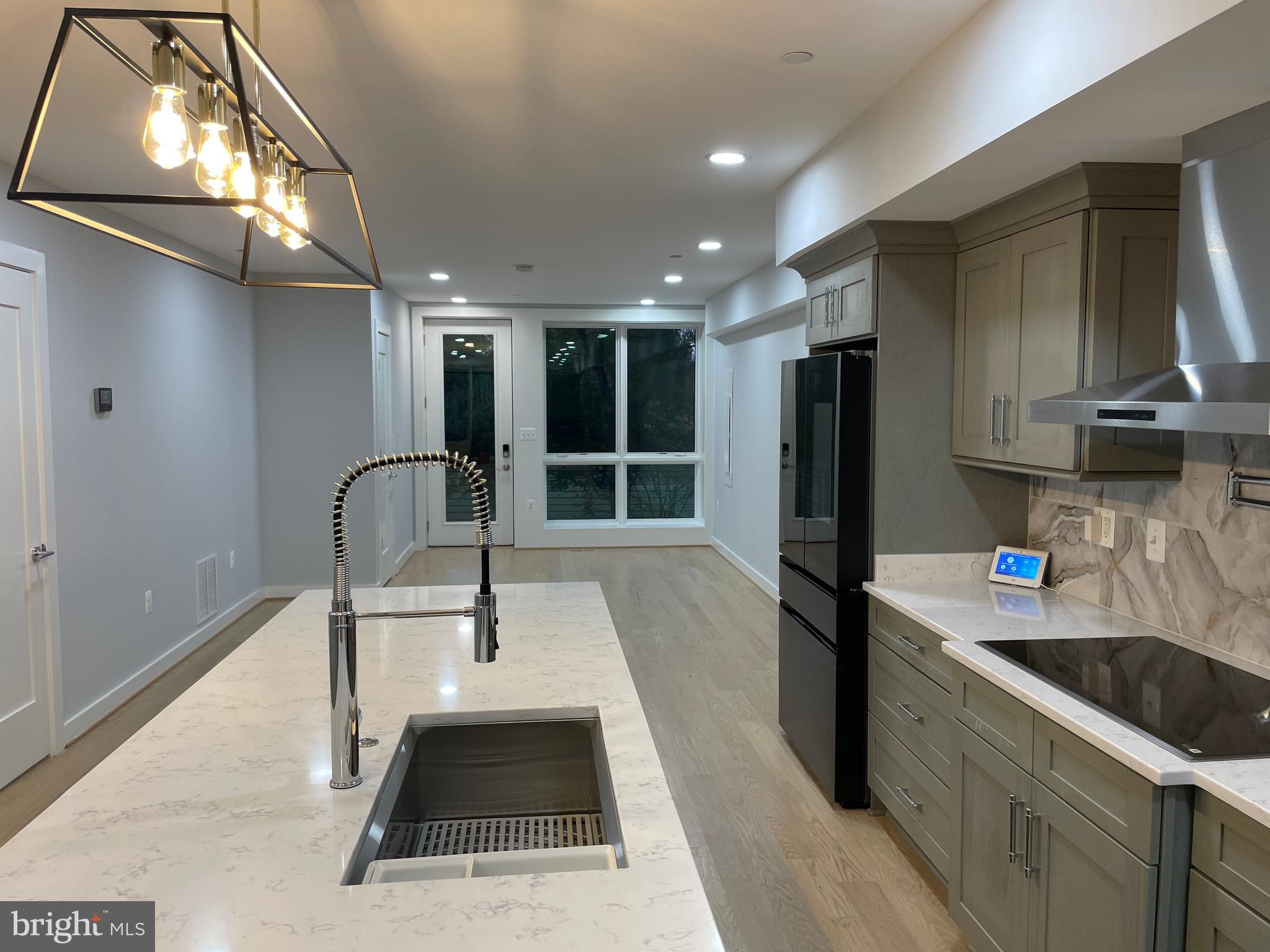 a kitchen with a sink a refrigerator and cabinets