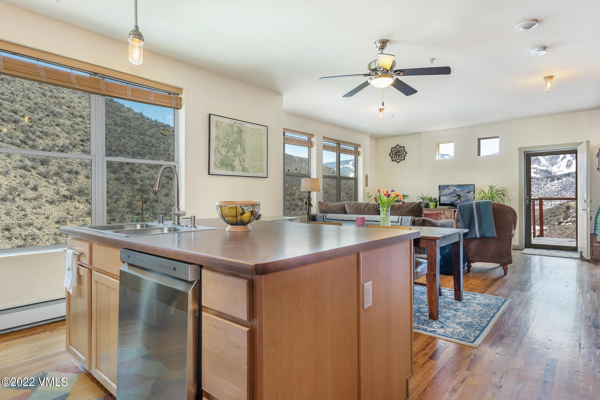 a kitchen with stainless steel appliances granite countertop a sink a stove and refrigerator