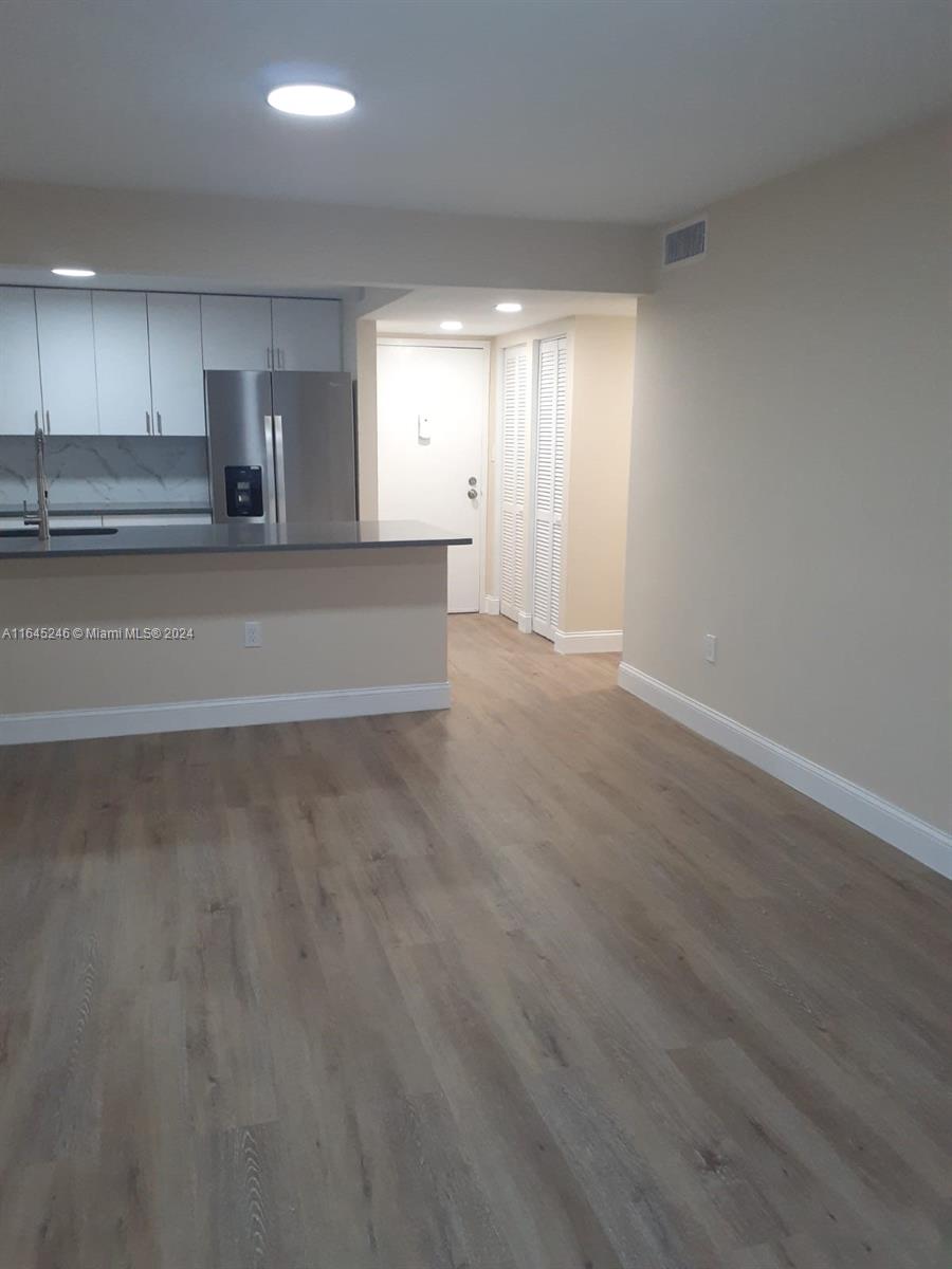 a view of a kitchen with a sink and dishwasher cabinets