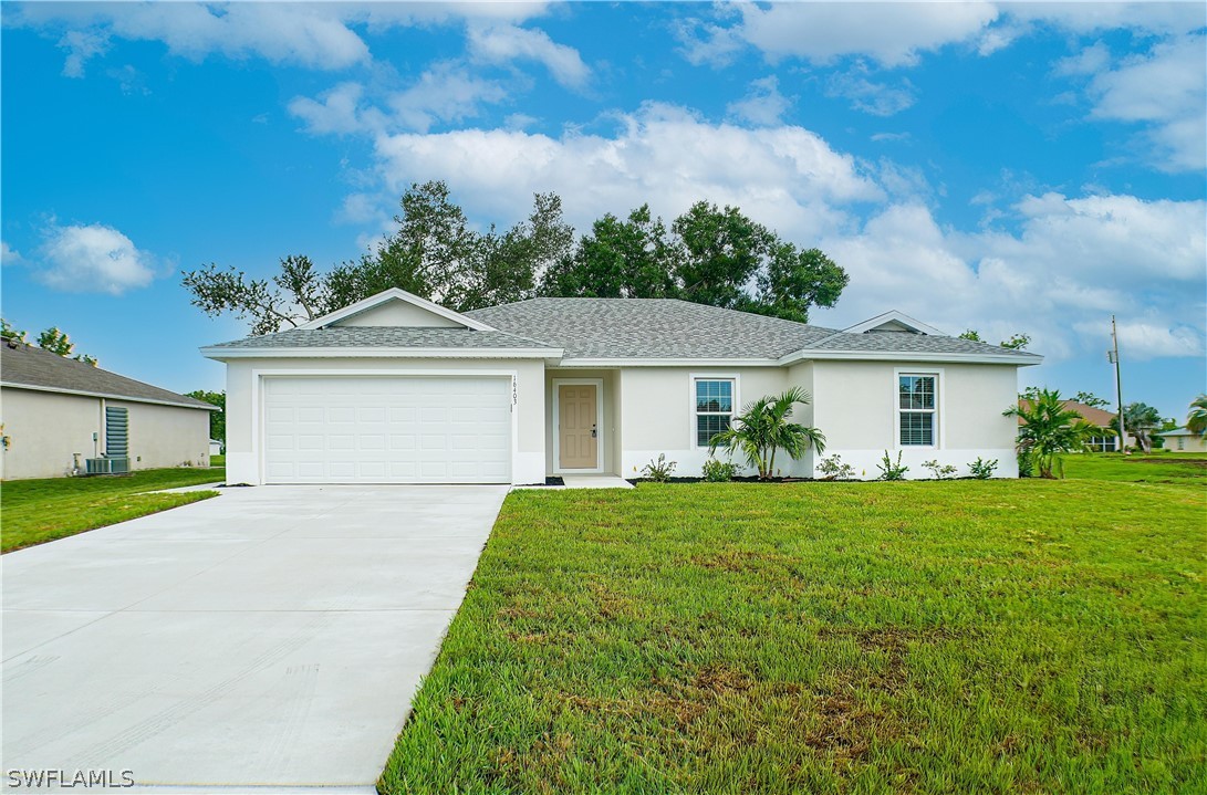 a front view of a house with a garden and yard