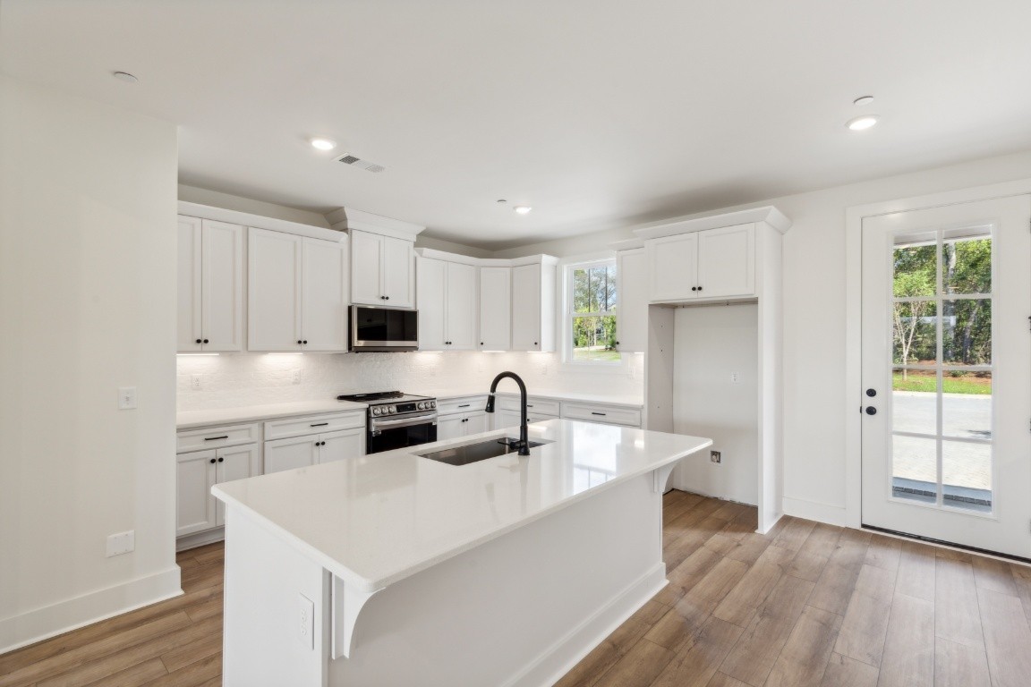 Actual photo of home. This is only part of your ENORMOUS kitchen! Soft-close drawers and cabinets, dovetail joinery, high-end LG appliances, and more storage space than you could ever need!