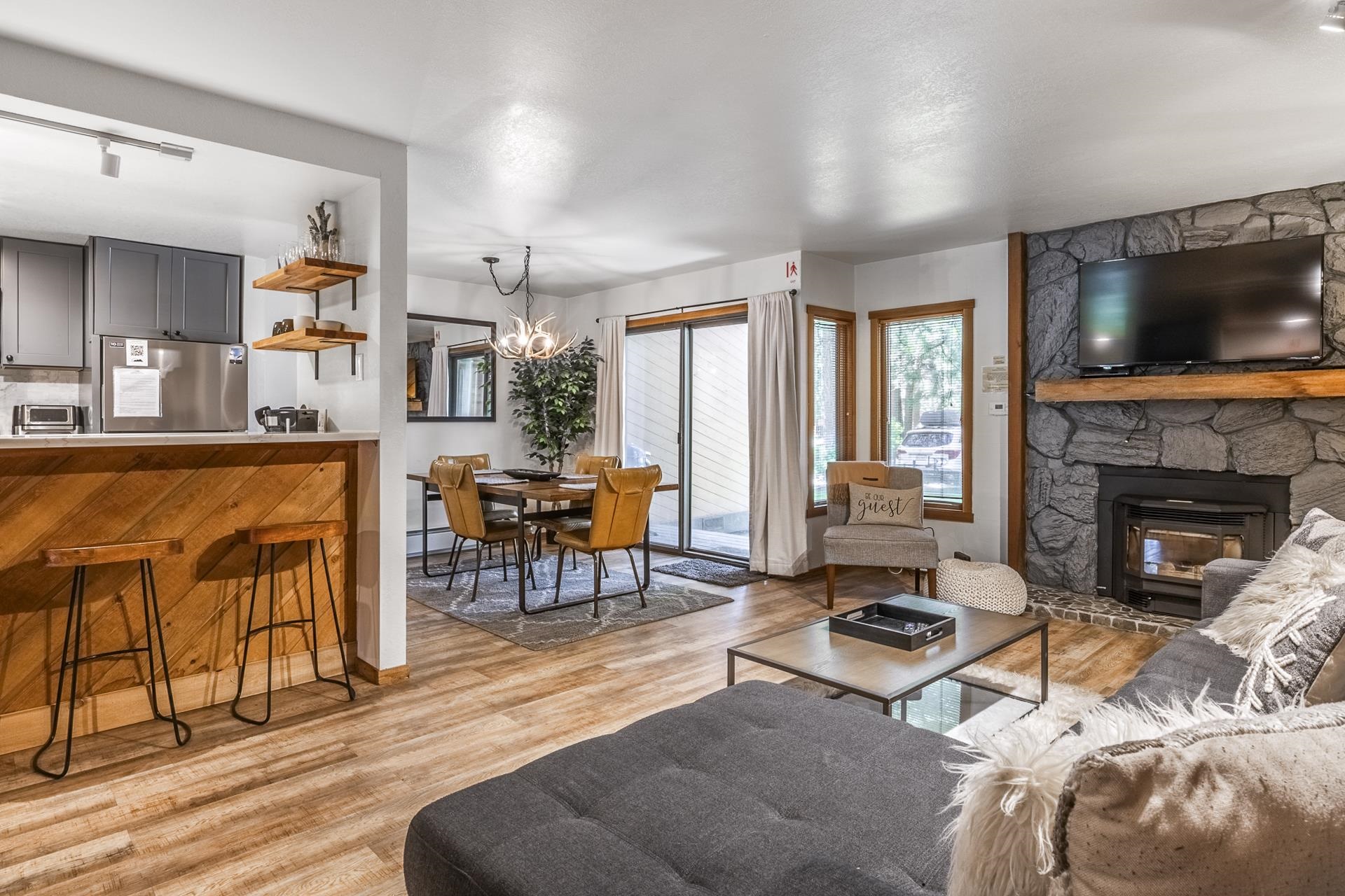 a living room with furniture a flat screen tv and a fireplace