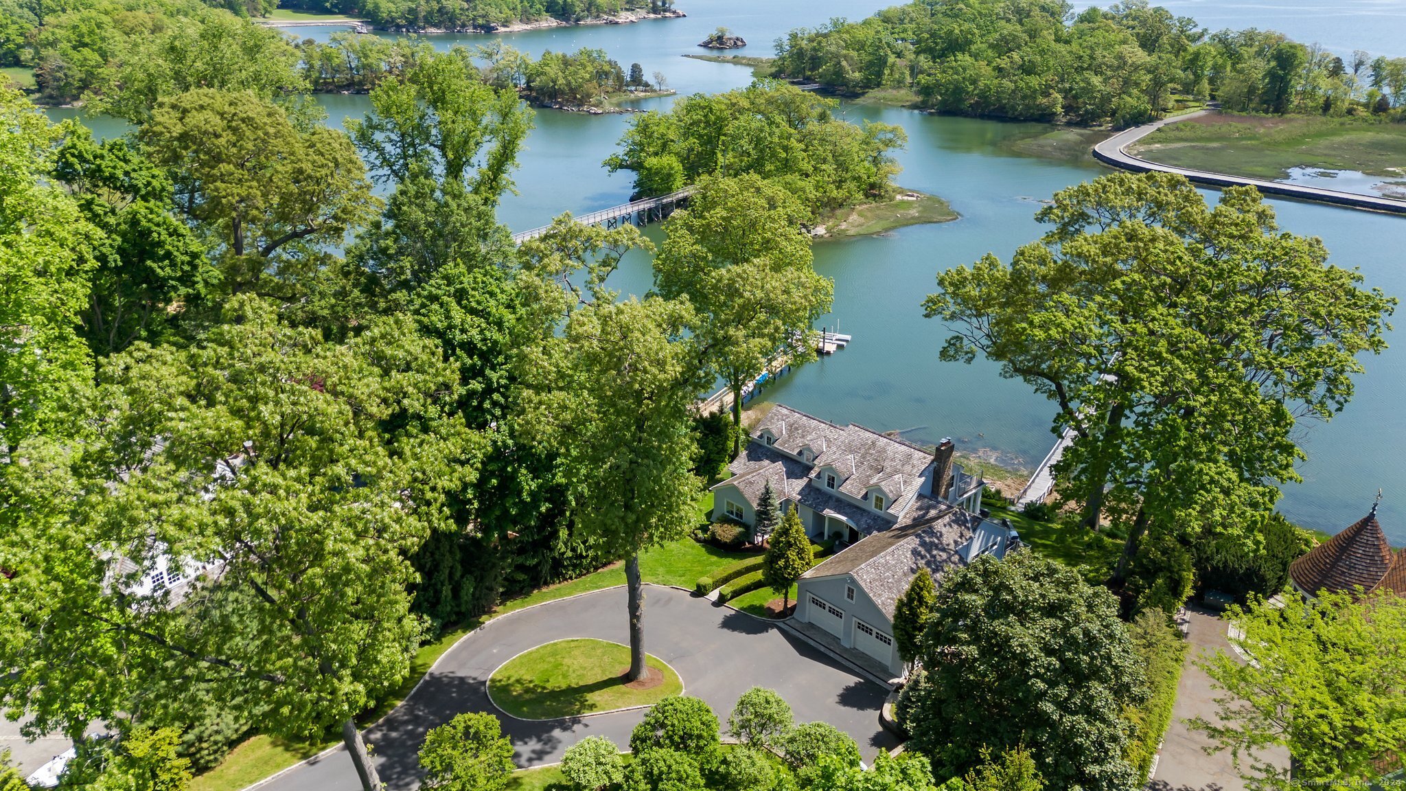 an aerial view of a house with a yard and lake view