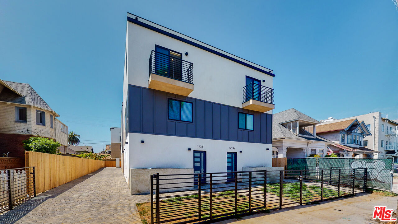 a view of a house with wooden fence