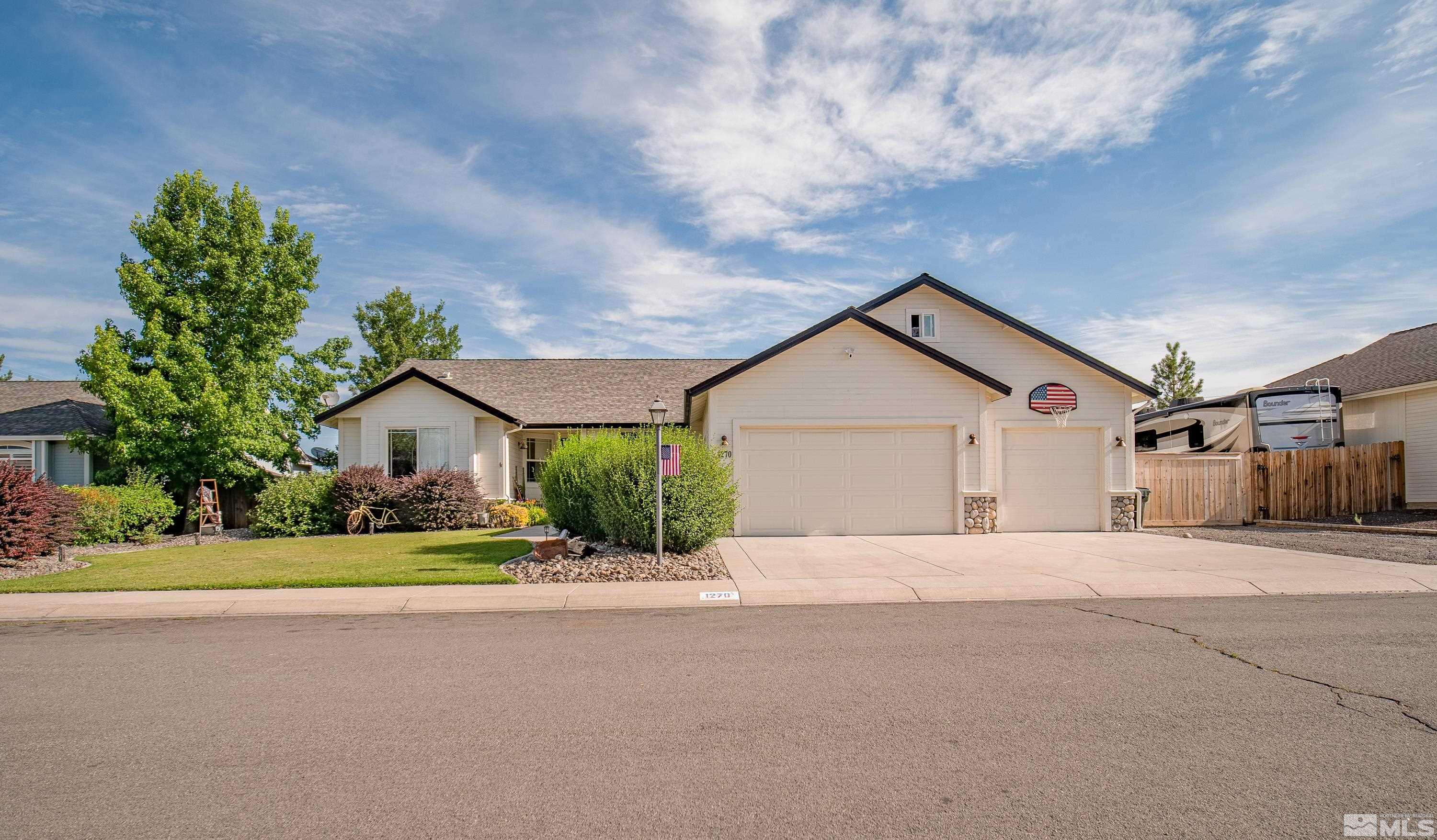 a front view of a house with a yard and a garage