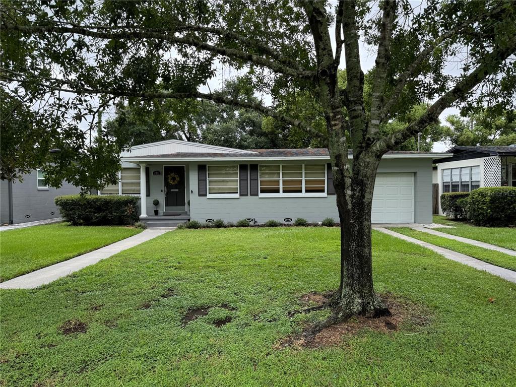 a front view of a house with a garden