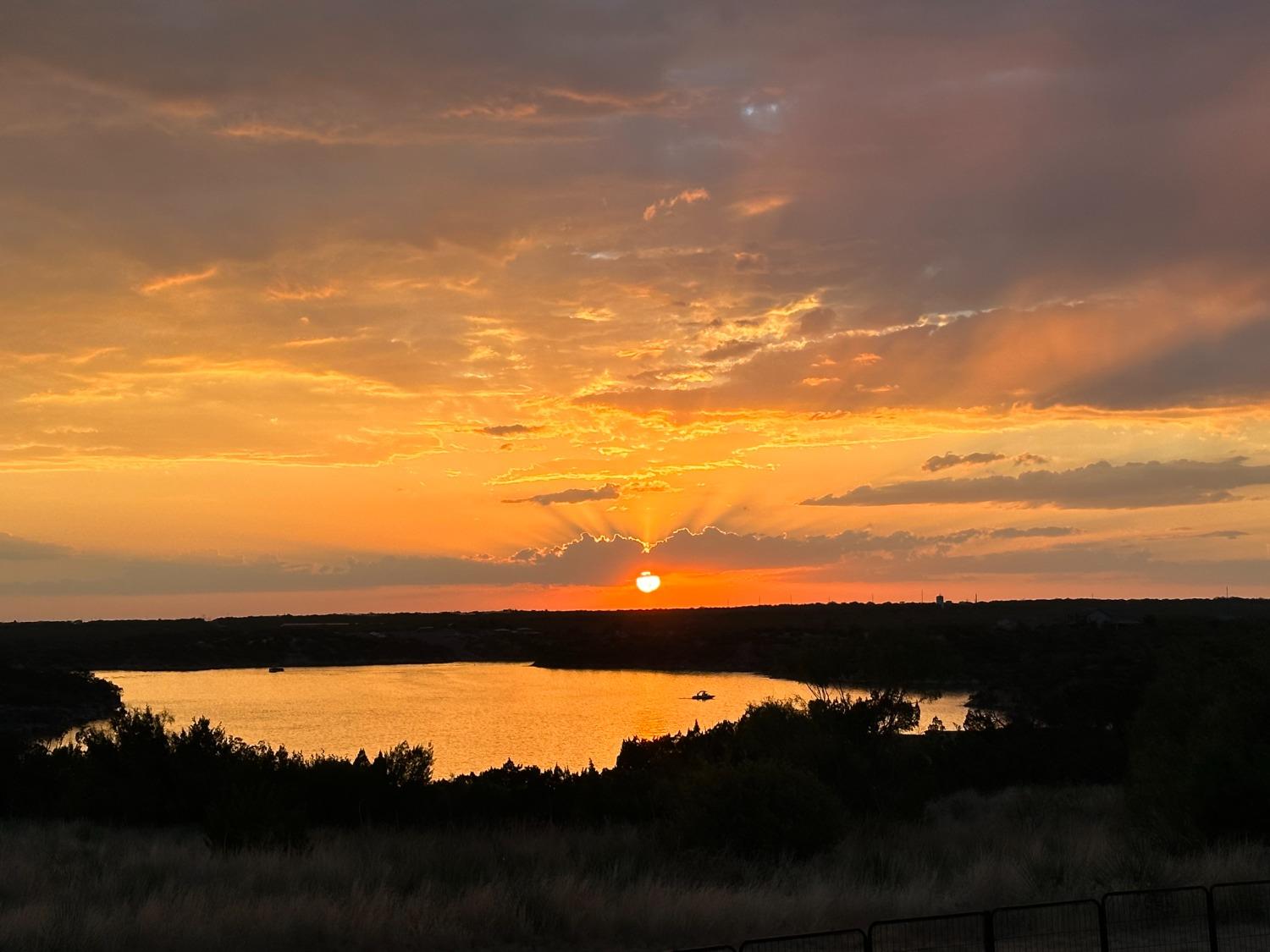 a sunset view with a lake