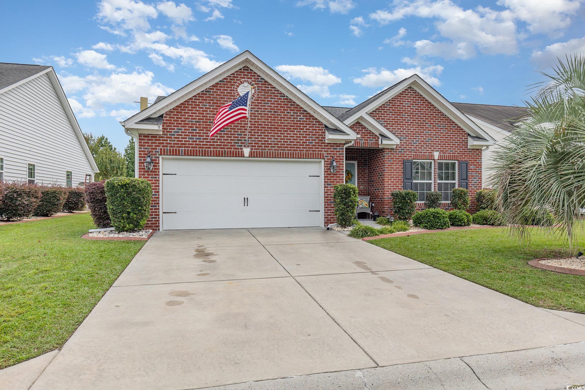 View of front facade featuring a garage and a fron