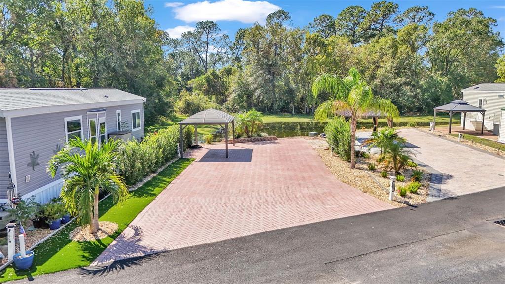 a view of a backyard with sitting area