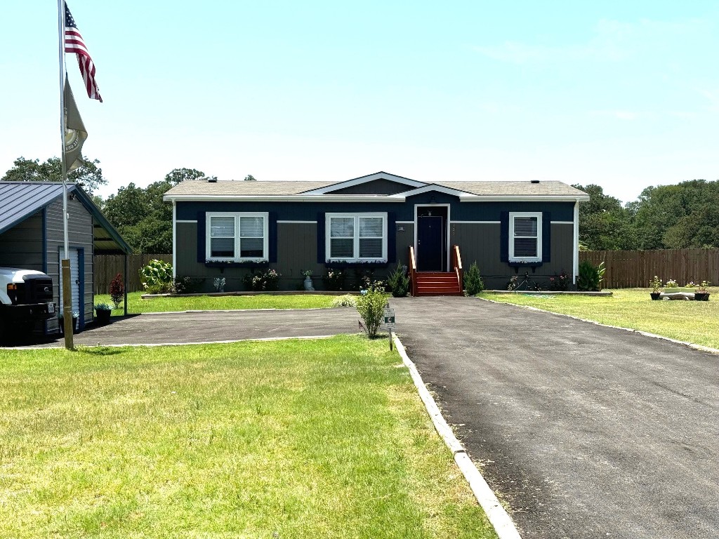 a view of a house with swimming pool and yard