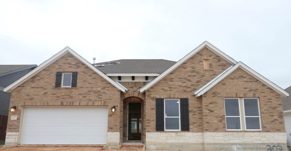 a front view of a house with garage