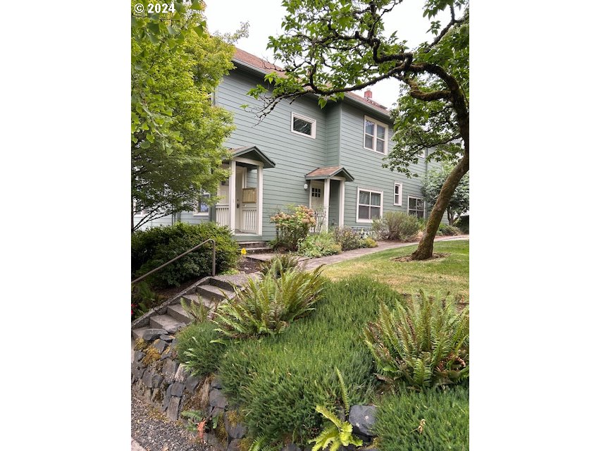 a front view of a house with garden