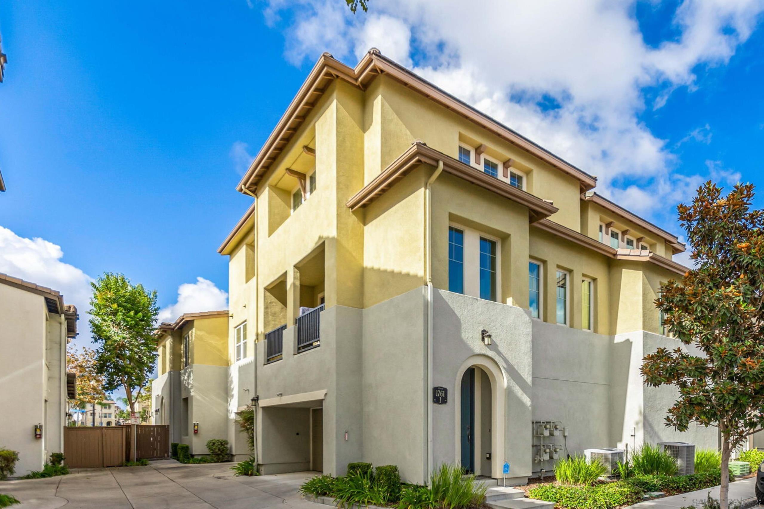 a front view of a residential apartment building with a yard