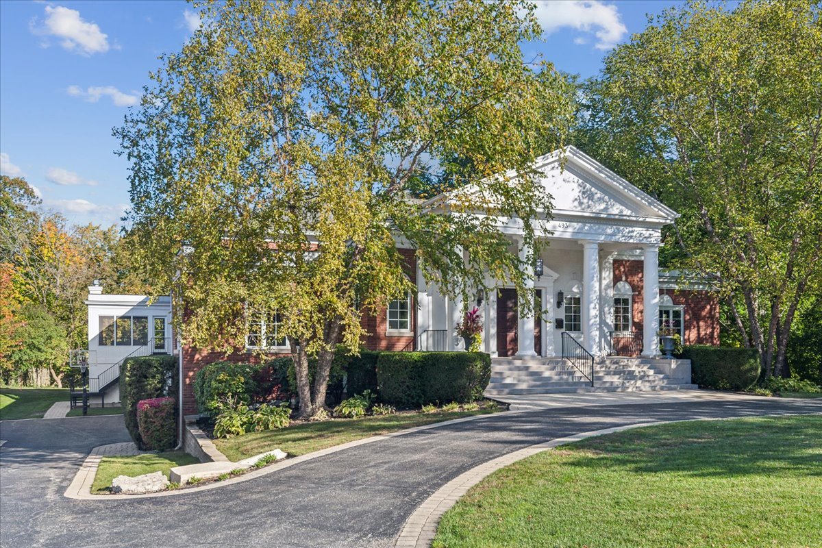 a view of a house with fountain and porch