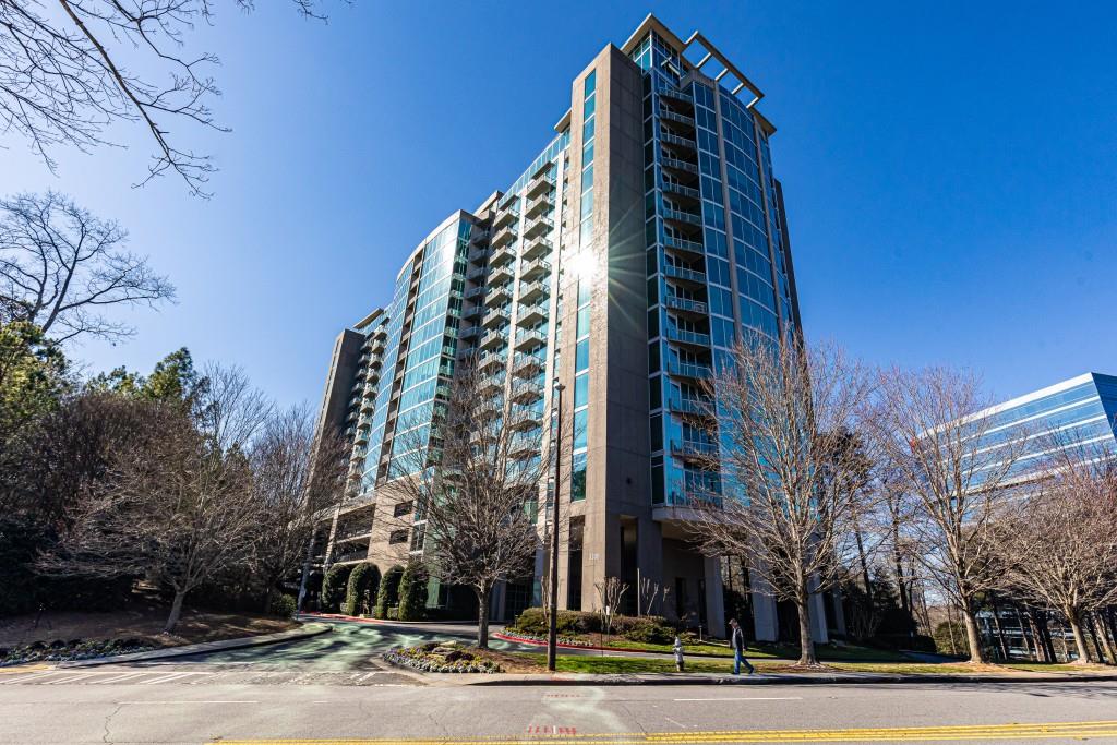 a view of a tall building next to a road