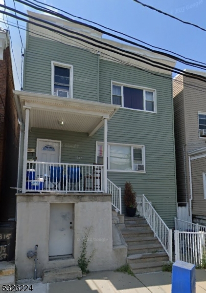 a view of a house with wooden deck