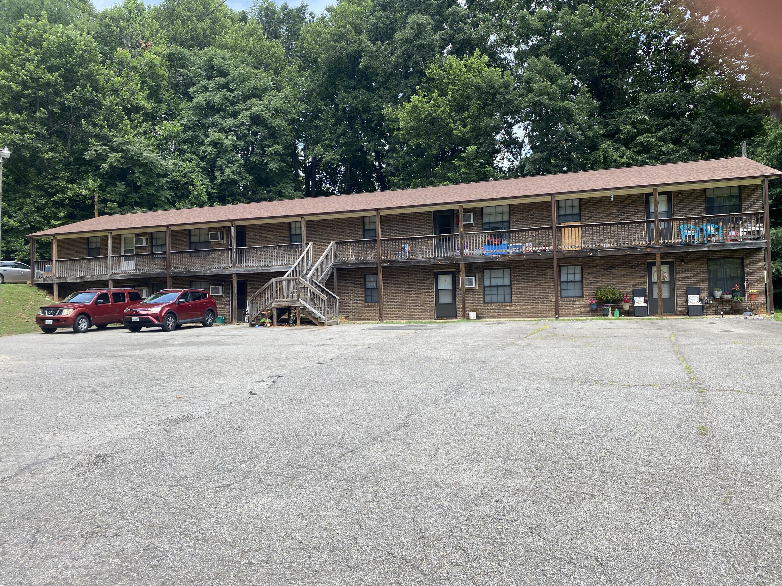 a view of house with outdoor space and parking