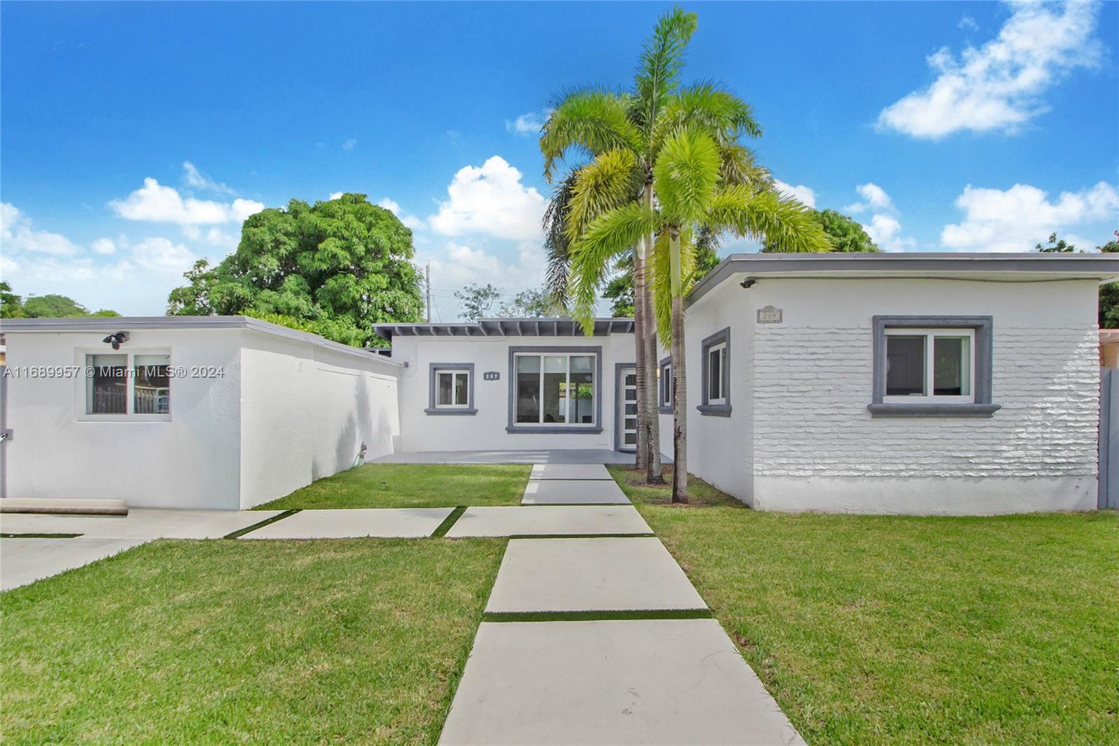 a front view of house with yard and green space