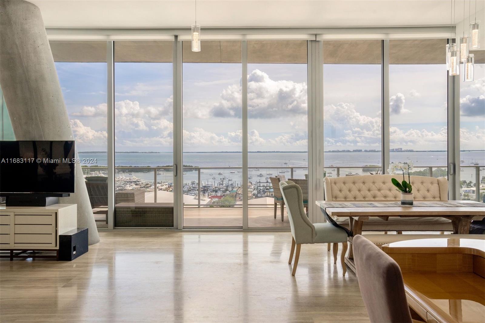 a dining room with furniture water view and a flat screen tv