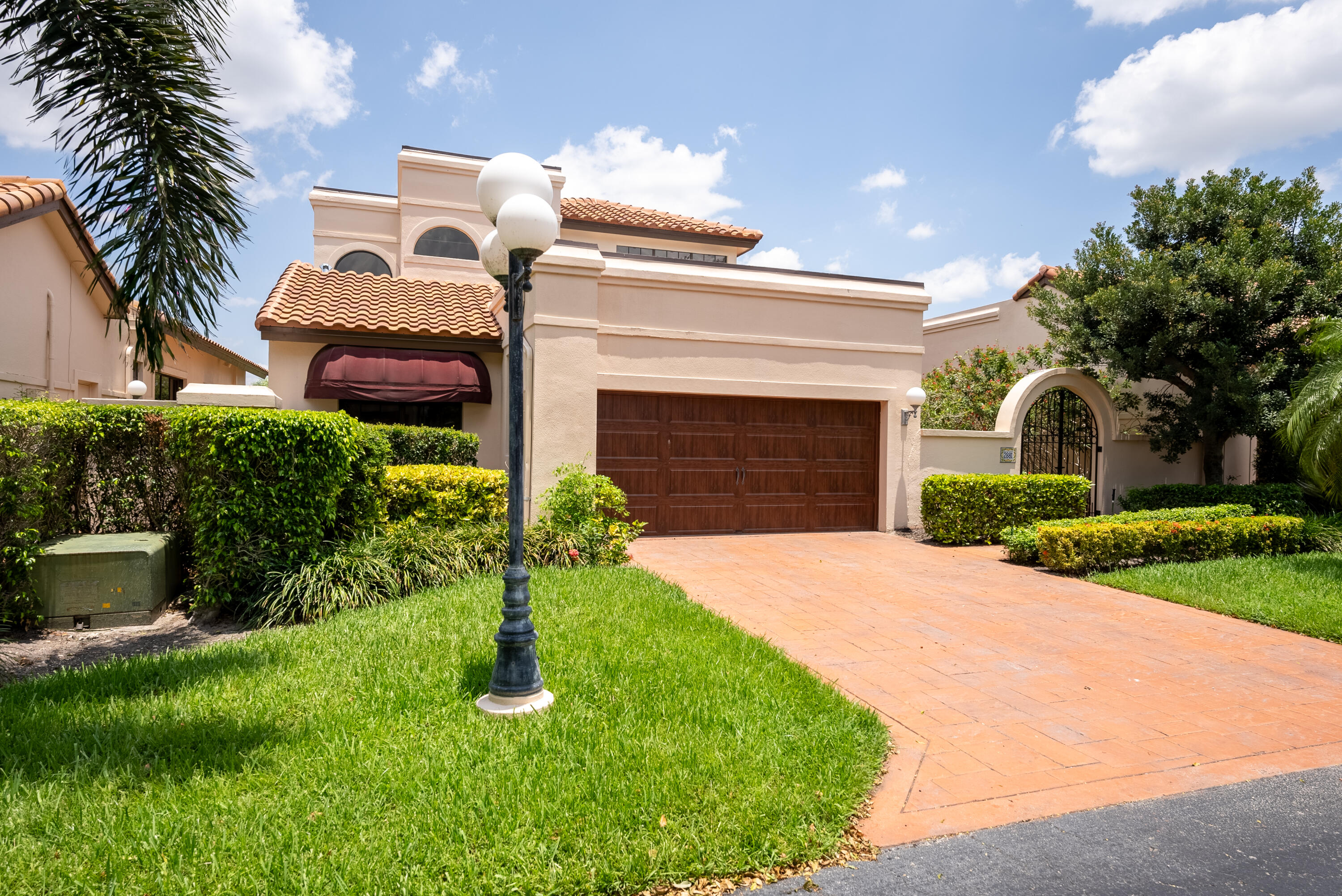 a front view of a house with a garden and yard