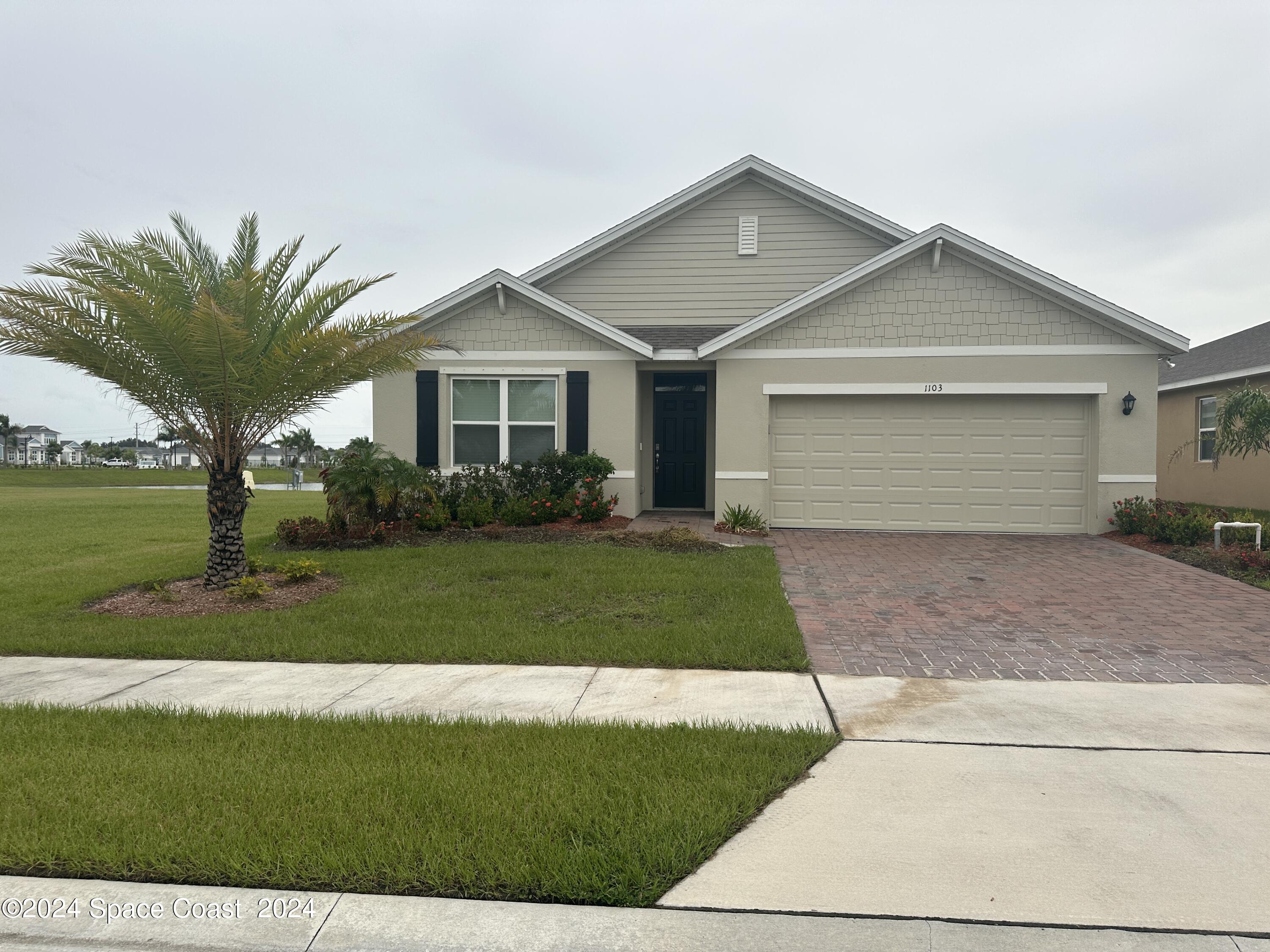 a front view of house with a garden